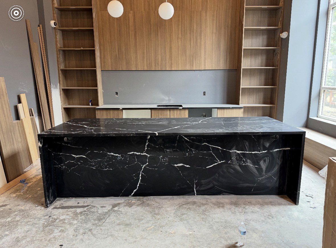 Black stone counter and cabinet wall installation