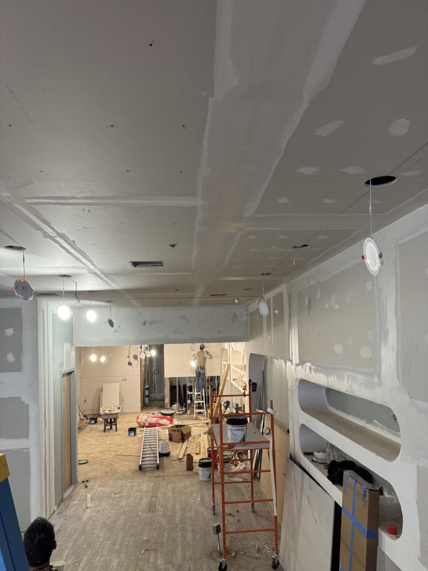 Nail salon construction site with ceiling and wall work